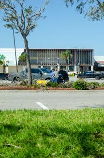 a parking lot with cars parked in front of a building by cody reed courtesy of Unsplash.