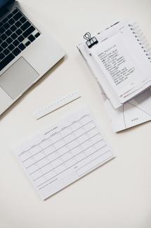 silver laptop computer near notebook by Marissa Grootes courtesy of Unsplash.