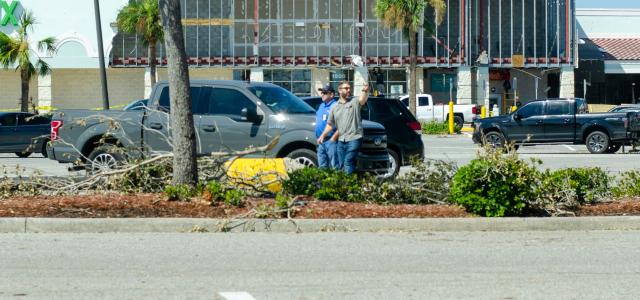 a parking lot with cars parked in front of a building by cody reed courtesy of Unsplash.