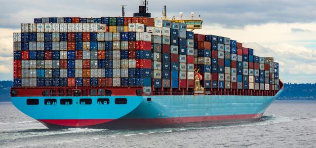 blue and red cargo ship on sea during daytime by Ian Taylor courtesy of Unsplash.